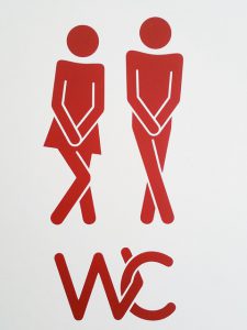 men women toilet sign holding it